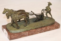 A bronze figure of a plough team