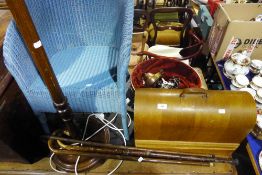 A Lloyd Loom chair, standard lamp, a sewing machine,