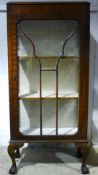 An early 20th century walnut display cabinet