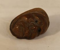 A carved coquilla nut head