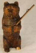 A carved Black Forest bear brush holder