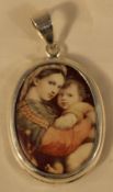 A silver Madonna and Child pendant