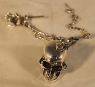 A silver skull watch chain