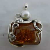 A silver framed pendant