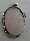 A silver and oval rose quartz pendant
