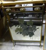 A painted brass framed fire screen