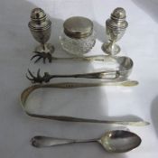 A pair of silver peppers, a silver topped trinket box,