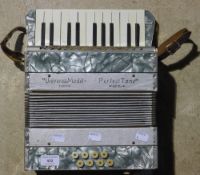 A boxed Perfect Tone piano accordion