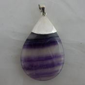 A silver and amethyst pendant