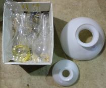 Two milk glass shades and a quantity of oil lamp flutes and spares