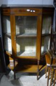 A Victorian glazed mahogany display cabinet with a brass galleried top