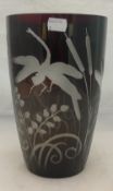 An etched glass vase decorated with dragonflies