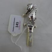 A silver sea horse rattle