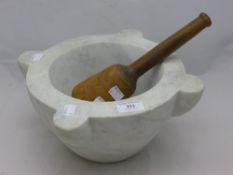 A large marble mortar and treen pestle