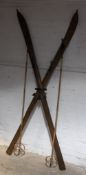 A pair of vintage skis formed as a coat stand and a pair of vintage ski poles