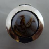 A silver pill box depicting a girl