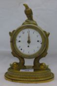 A 19th century ormolu mantel clock with fish supports and eagle finial