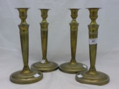 A set of four brass candlesticks