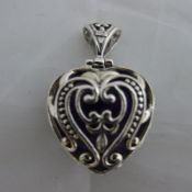 A silver and amethyst heart pendant