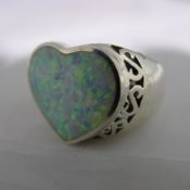 A silver and opal heart ring