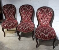 Three Victorian walnut framed button upholstered spoon back chairs