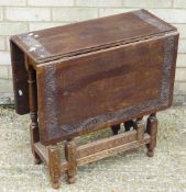 A Victorian carved oak drop leaf table