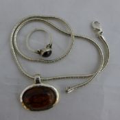 A silver and amber necklace and ring en-suite