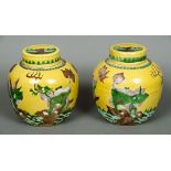 A pair of Chinese yellow ground ginger jars Each decorated in the round with mythical beasts.