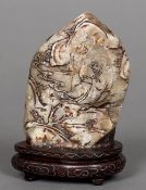 A Chinese hardstone pebble carving Decorated with scholarly figures in a mountainous landscape,