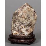 A Chinese hardstone pebble carving Decorated with scholarly figures in a mountainous landscape,