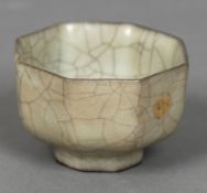 A Chinese Guan porcelain crackle glaze tea bowl Of octagonal section, standing on a shallow foot,