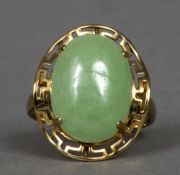 A 9 ct gold jade set ring The cabochon stone above the pierced shoulder. 1.75 cm wide.