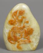 A Chinese carved green and russet jade bolder form seal Carved to one side with dragon and