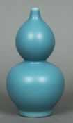 A Chinese porcelain double gourd vase With allover blue glaze,
