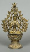 A Chinese gilt bronze figure of a multi-armed deity Modelled seated before a pierced arch,