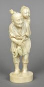 A late 19th/early 20th century Japanese carved ivory okimono Worked as a gentleman holding his days
