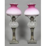 A pair of Victorian silver plated Corinthian column oil lamps With cut glass reservoirs and