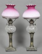 A pair of Victorian silver plated Corinthian column oil lamps With cut glass reservoirs and