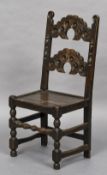 A 17th century oak chair The shaped back above the panelled seat,