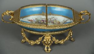 A Sevres style glass topped gilt mounted porcelain casket With double hinged top above the