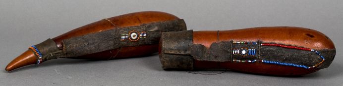 A pair of African, possibly Masai, gourd form storage vessels Each with beaded decorations.