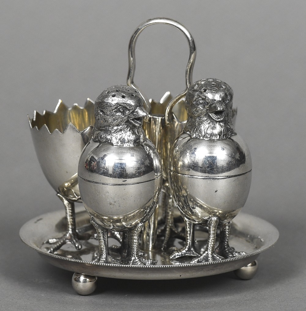 A silver plated cruet set The two egg cups with triple chicken legs formed as a broken egg;