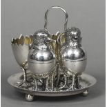 A silver plated cruet set The two egg cups with triple chicken legs formed as a broken egg;