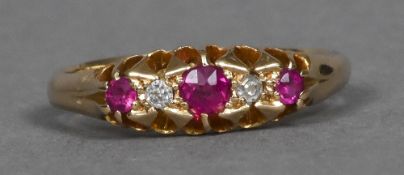 A Victorian 18 ct gold ruby and diamond five stone ring With three rubies interspersed by two small