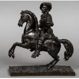 A 19th century patinated bronze figure Modelled as a cavalier astride his rearing mount.