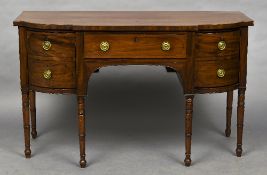 A 19th century mahogany breakfront sideboard The shaped top above three frieze drawers with ring