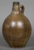 A 17th century stoneware Bellarmine mask flagon The bulbous body with moulded prunt and loop handle.