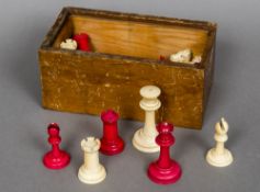 An early 20th century ivory and stained ivory Staunton pattern chess set The Kings approximately 6.