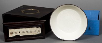 A Chinese song type bowl Celadon glazed with floral anhua decoration within a white metal mounted