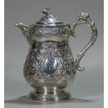 An Edwardian Irish silver embossed lidded jug, hallmarked Dublin 1907,